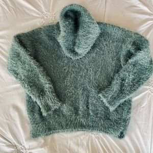 Soft fuzzy sage green sweater with loose cowl type turtleneck